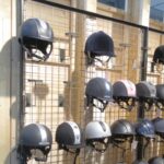 Equestrian shop-fittings - Riding hats on mesh